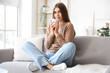 © Pixel-Shot - Young woman with cup of hot tea at home