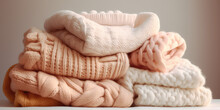 A Pile Of Knitted Sweaters, Light Soft Pastel Colors Palette. Warm Handmade Sweaters For Fall Weather.