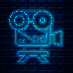 Wall Mural - Glowing neon line Retro cinema camera icon isolated on brick wall background. Video camera. Movie sign. Film projector. Vector