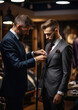 © Julia Zarubina - Generative AI, a tailor in an expensive suit sews a jacket to order for a client, an elite sewing workshop, a luxury clothing store, a businessman at work, a man takes measurements, fabric, salon