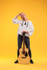 Poster - Happy hippie woman with guitar on yellow background