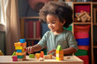 © arhendrix - A young African American toddler playing with colorful wooden block toys