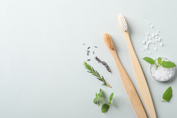 Flat lay composition with toothbrushes and herbs on white background. Space for text