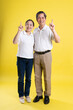 © 1112000 - portrait of middle aged asian couple posing on yellow background