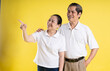 © 1112000 - portrait of middle aged asian couple posing on yellow background