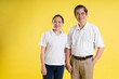 © 1112000 - portrait of middle aged asian couple posing on yellow background