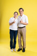 © 1112000 - portrait of middle aged asian couple posing on yellow background