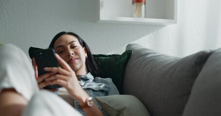 Canvas Print - Happy woman, thinking and relax with smartphone on sofa, scroll social media and reading notification at home. Cellphone, smile and search connection, download digital app and contact in living room