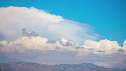 Wall Mural - Beautiful Cumulonimbus Cloud Formations Sweep Across the Blue Skies Over the Latvian Landscape Below.