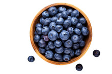 Fresh blueberry in a wooden bowl. Juicy and fresh blueberries with green leaves on a white background