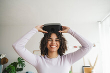 Happy Teenage Girl With Virtual Reality Simulators At Home