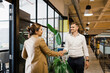 © Westend61 - Businesswoman greeting colleague standing at office