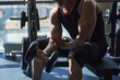 © Westend61 - Man exercising with dumbbell in gym