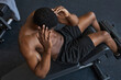 © Westend61 - Man doing curl up exercise in gym