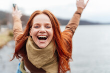 Cheerful woman shouting and enjoying at lake