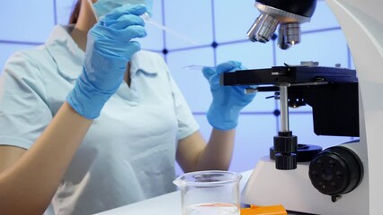 Sticker - laboratory assistant examines a drop of water