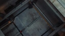 Cars Leaving An Underground Parking Lot, Shot From A Drone, Top View, Camera Zooming To The Ground
