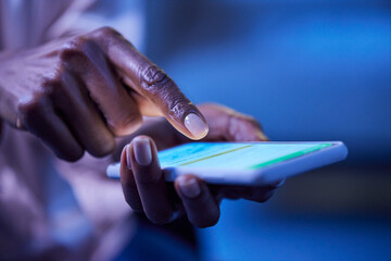 Black woman typing on mobile phone during night
