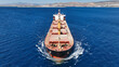 Aerial drone photo of bulk carrier ship carrying heavy merchandise and cruising deep blue open ocean sea