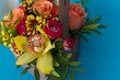 Bouquet with orchids on a blue background