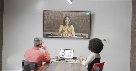 Wall Mural - Diverse business people on video call with caucasian female colleague on screen