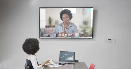 Wall Mural - African american businesswoman on video call with african american female colleague on screen