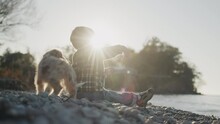 A Purposeful Boy Of Two Years Throws A Stone Into The Sea. Rear View, Slow Motion Video