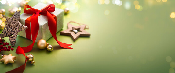 Wall Mural - christmas greeting card or christmas banner design - gift box and ornaments on light green backgroun