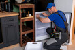 © Grustock - An electrical technician working on the repair of a refrigerator or refrigeration equipment.