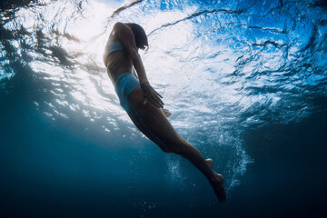 Wall Mural - Woman underwater swim with ocean wave and sun rays.