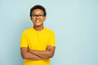 © Maria Vitkovska - Portrait of smiling African American boy in yellow casual t shirt wearing glasses with crossed arms