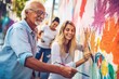 Retirees paint a mural on a street wall.