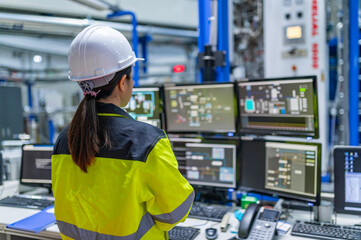 inside the large industry factory female computer engineer works on personal computer she coding pro