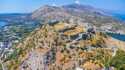 Wall Mural - Aerial drone view of Rozafa Castle in the city Shkoder and its walls next to the lake and the river. Albania