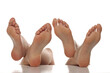 Two pairs od a beautiful well-groomed women's sole feet close-up on a white isolated background, The concept of foot skin care