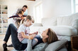 © Geber86 - Young family playing with each other and having fun in the living room at home