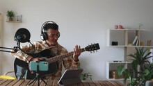 Young Man With Guitar Recording With Microphone, Influencer Recording Live For His Audience. Tutorial, Teacher, Online Classes