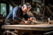 © sirisakboakaew - Joiner working with wooden detail in the workshop