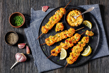 Wall Mural - Bang Bang Chicken Skewers on plate, top view