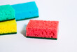 © Tanya Demchenko - Colored sponges for dishes on a white background.