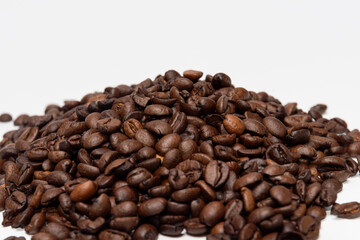 Wall Mural - Coffee beans on a white table. Roasted coffee beans on a white background, top view, copy space.coffee beans on a white background