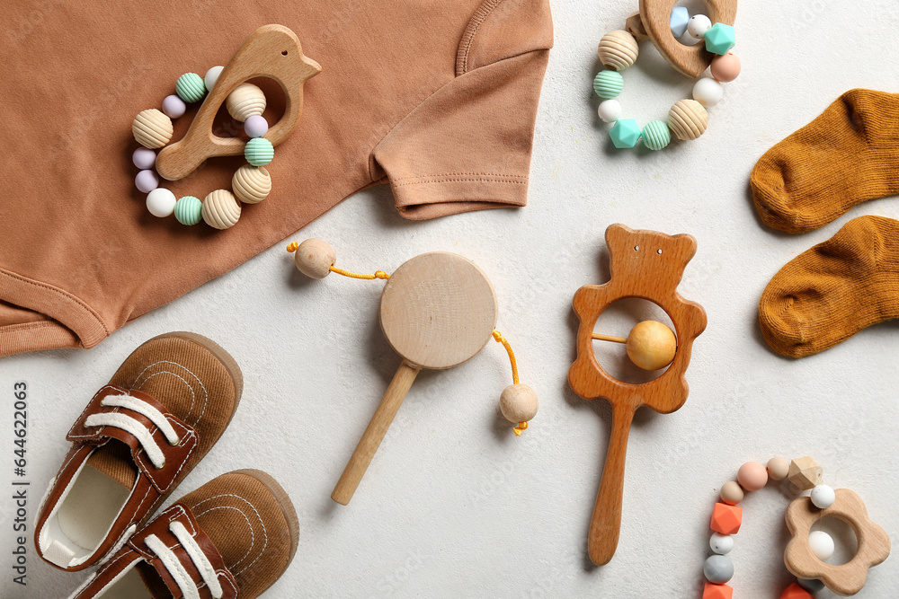 Composition with baby accessories and clothes on light background