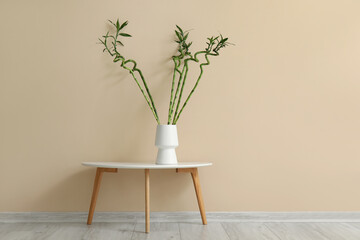 Wall Mural - Vase with bamboo stems on table near color wall