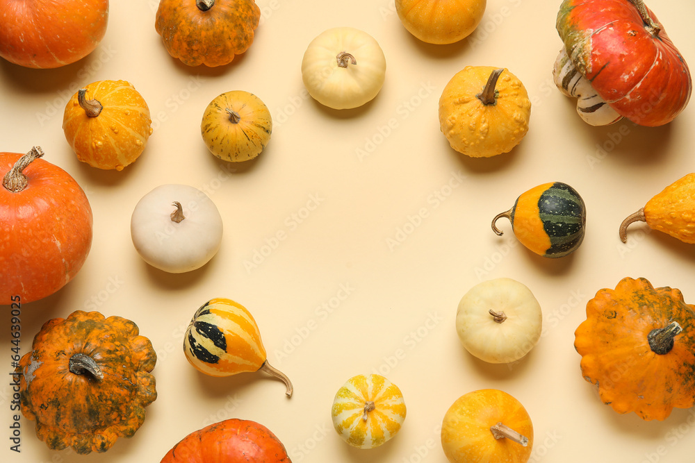 Frame made of different fresh pumpkins on yellow background