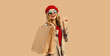 Autumn style outfit, portrait of beautiful happy smiling young woman with shopping bags wearing red french beret hat, gray coat jacket on beige studio background