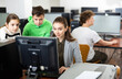 © JackF - Female teacher and her students, young girl and boy, looking at monitor of PC during computer science lesson.
