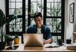 © ibreakstock - GenZ Asia man smiling in cozy home office, work from home wfh people concept