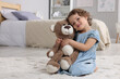 © New Africa - Cute little girl with teddy bear on floor at home