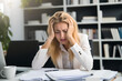 Burnout young woman working at office desk feeling sick at work, exhausted female worker with frustrated, stressed out woman with head in hand