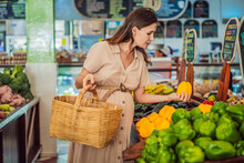 A Glowing Pregnant Woman After Forty Makes A Healthy Choice As She Selects Organic Vegetables And Fruits At The Vibrant Organic Market, Prioritizing Her Well-being And Her Baby's Health